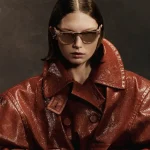 Model wearing Rayban Meta Skyler glasses with Shiny Transparent Peach frames and Brown Transitions® lens.