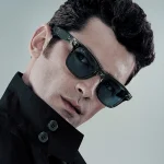 Model wearing Rayban Meta Wayfarer glasses with Shiny Transparent Grey frame and Sapphire Transition lenses.